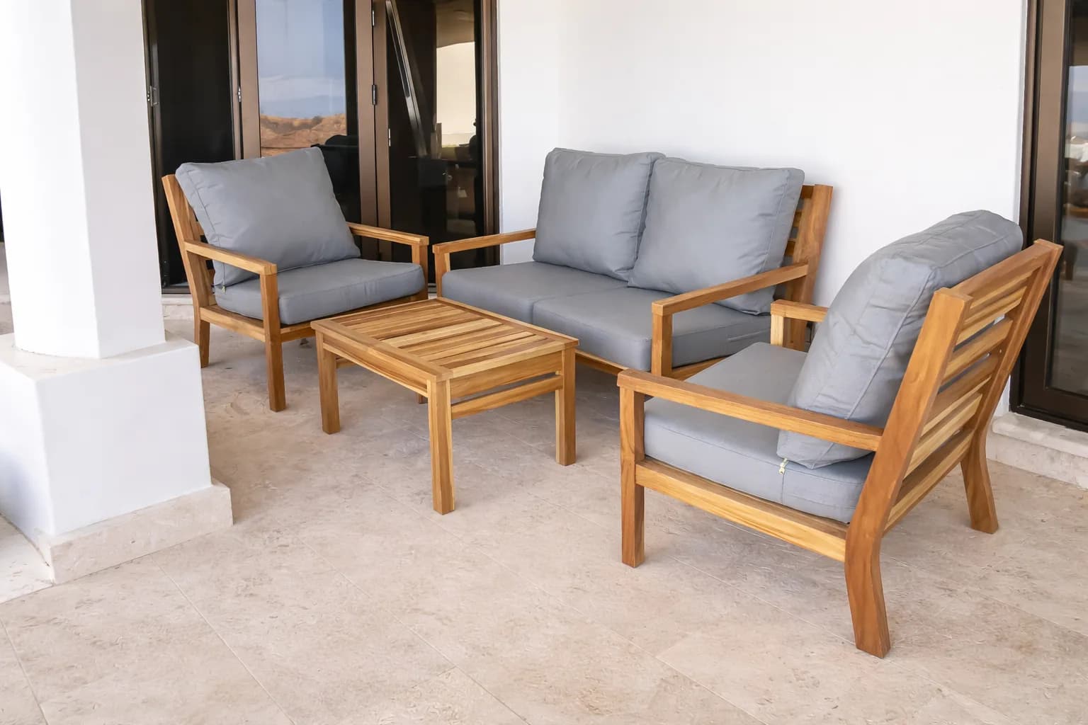 Outdoor teak lounge set with upholstered cushions