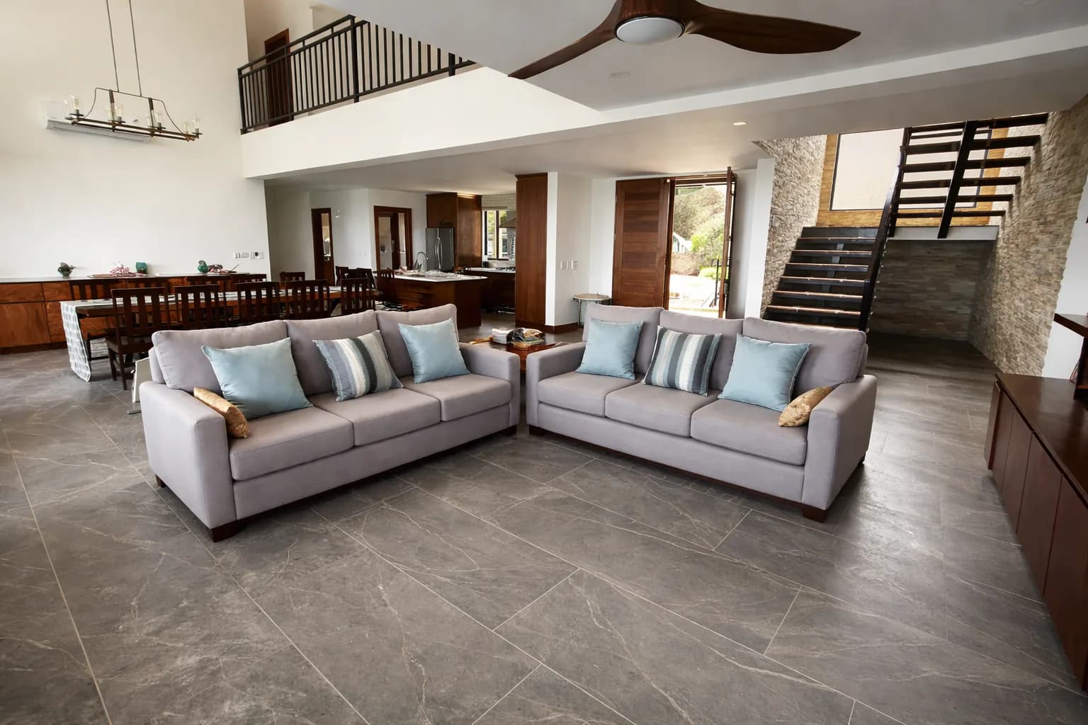 Furnished living room with sofas and custom wood pieces