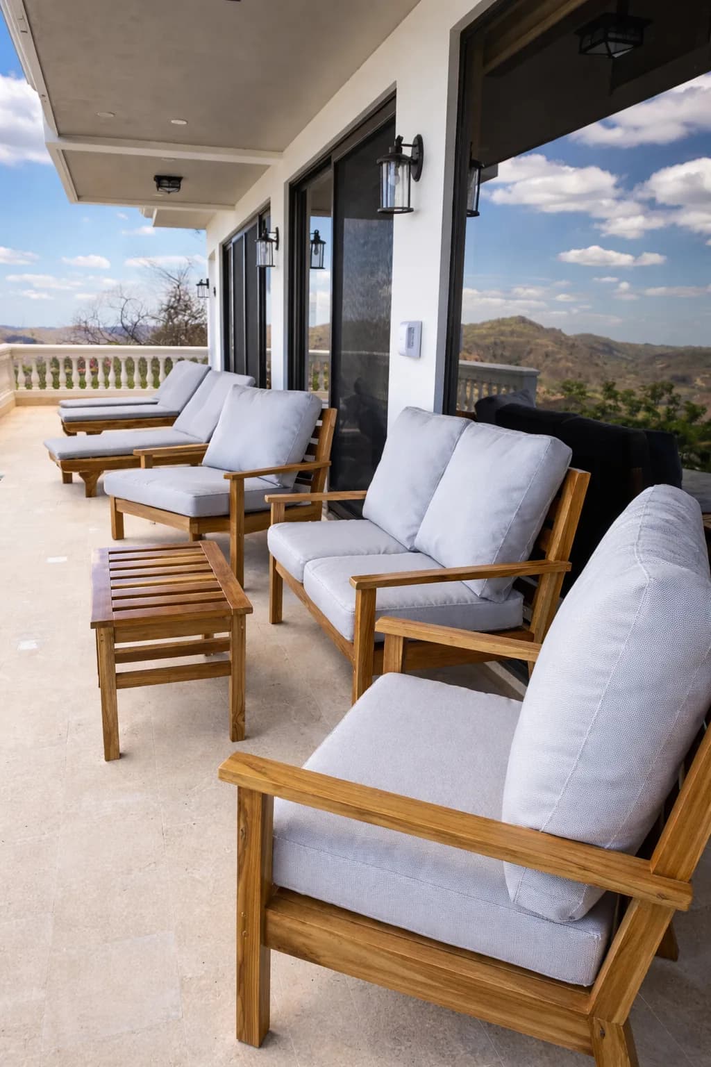 Teak seating arranged along a covered terrace