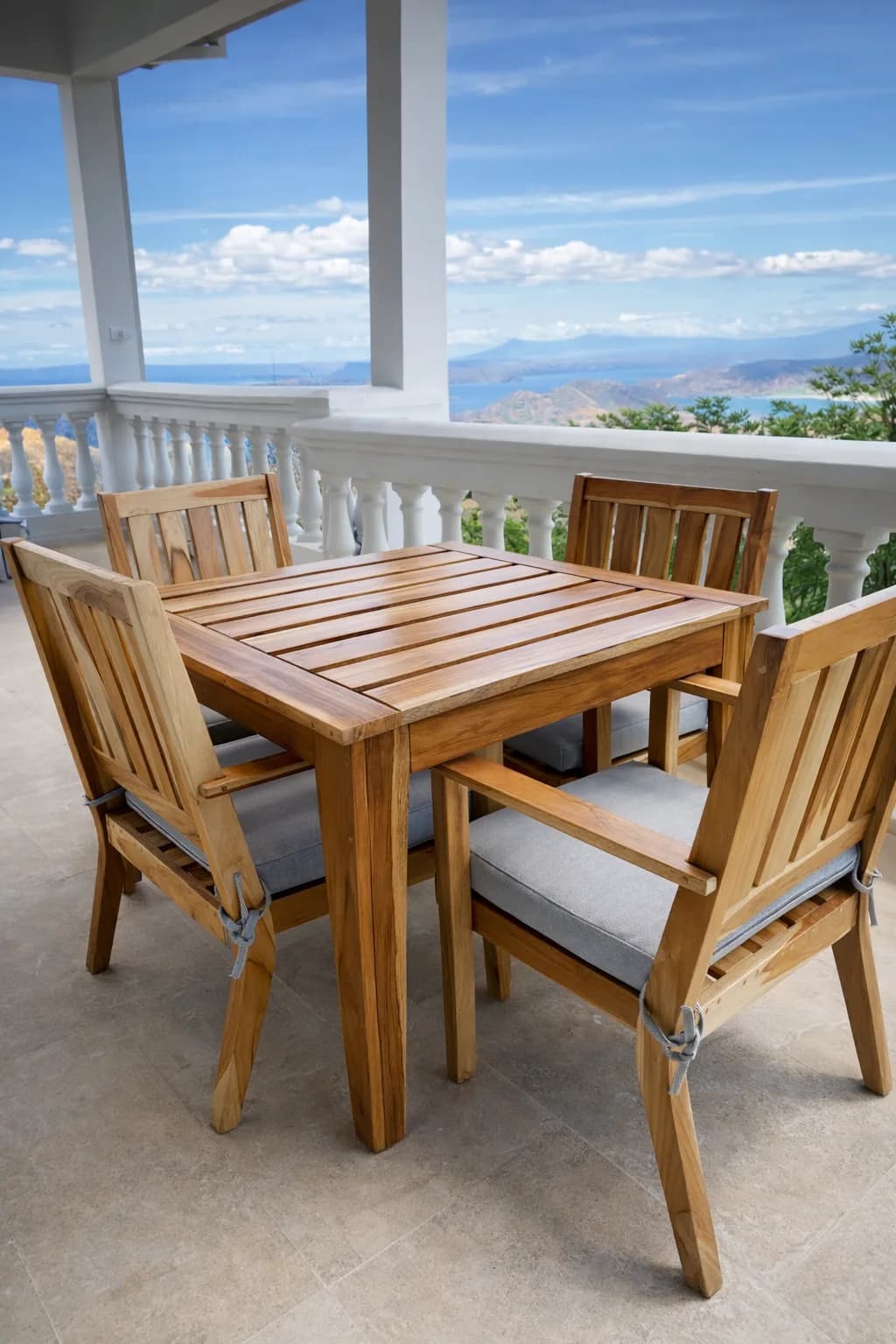 Outdoor wood dining set overlooking the coast