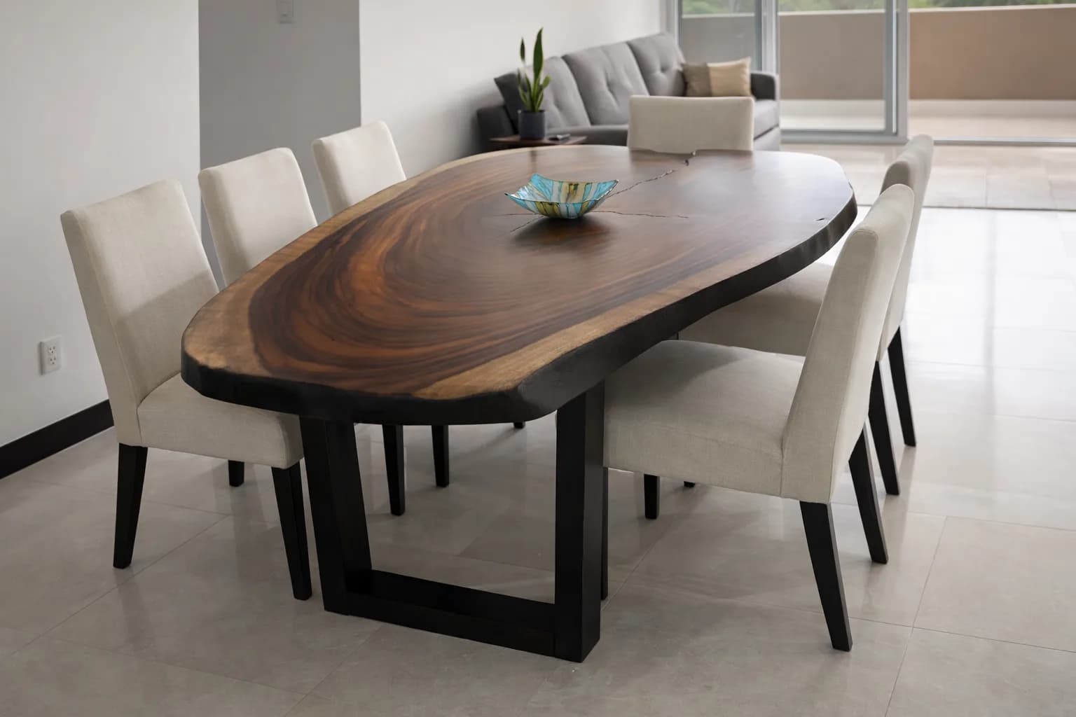 Oval live-edge dining table with upholstered chairs
