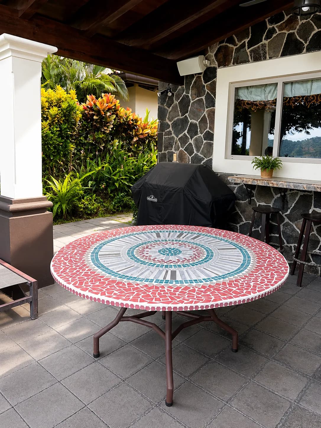 Round mosaic table on a garden terrace
