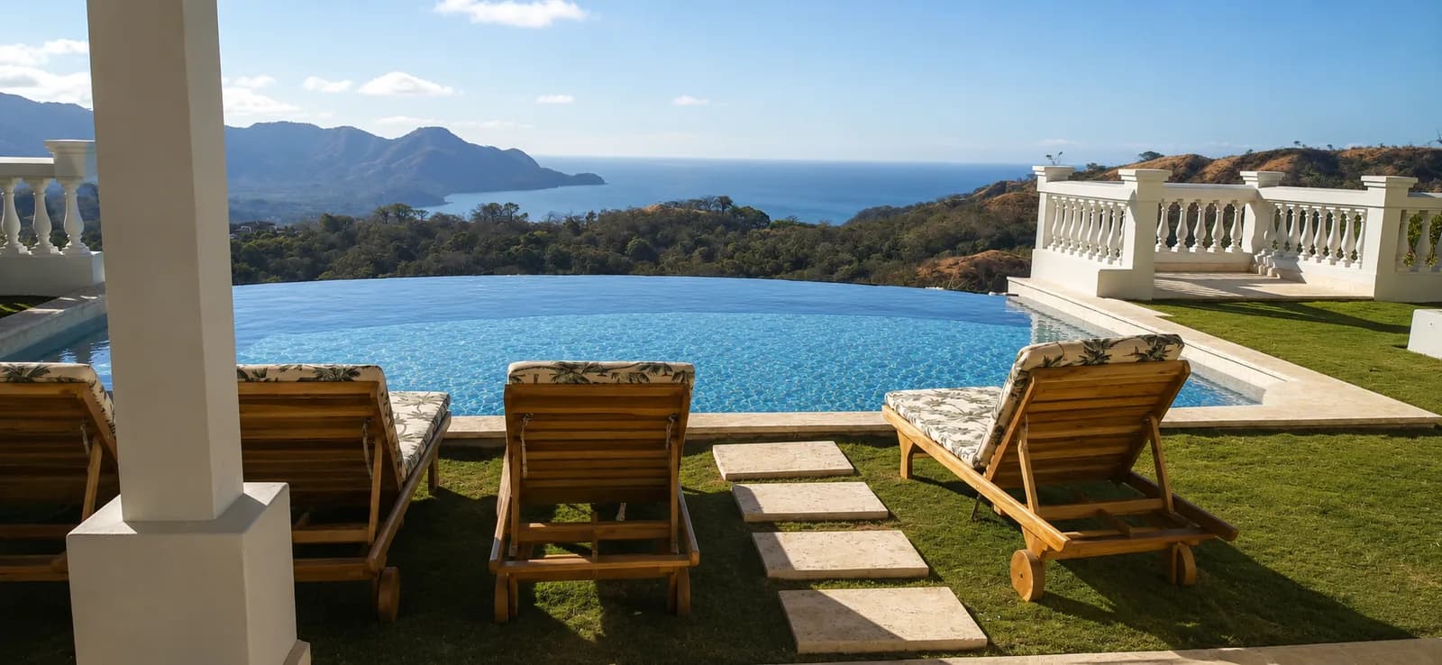 Poolside wood loungers overlooking the Costa Rican coast