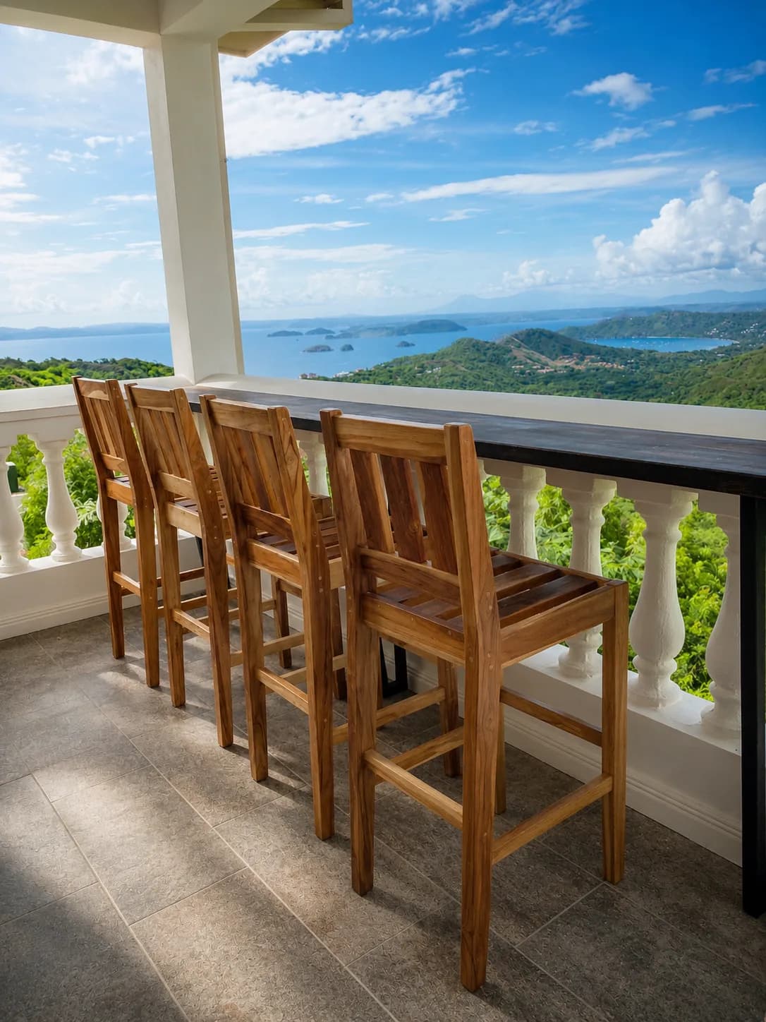 Wood bar stools at an outdoor counter with an ocean view