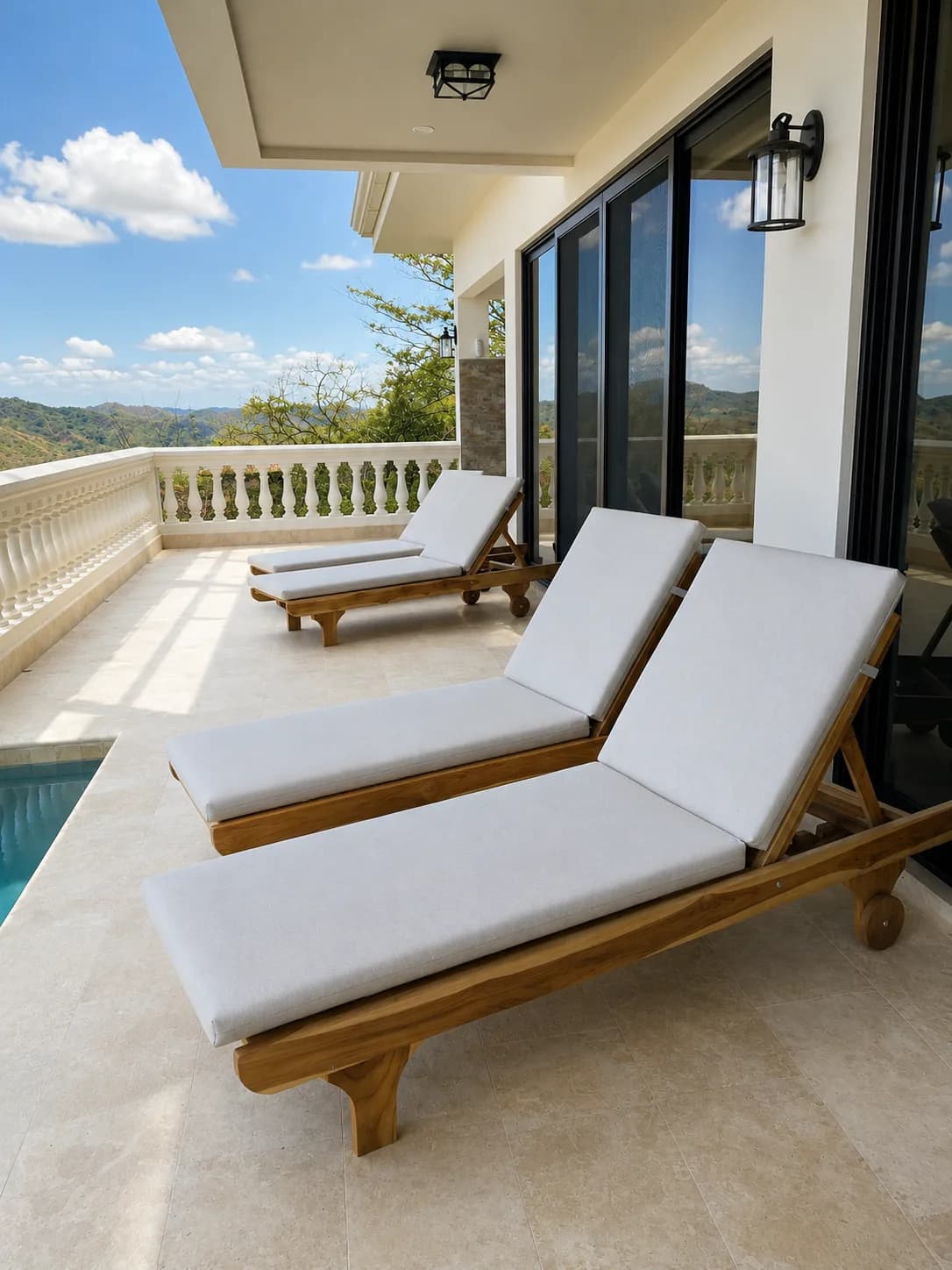 Upholstered wood chaise lounges beside a pool